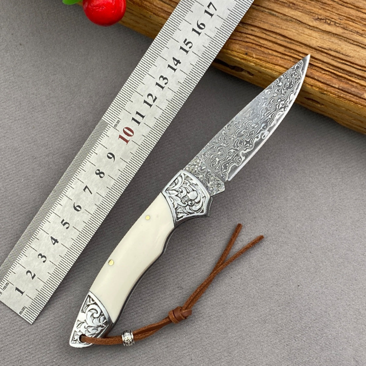 Handmade Damascus Steel Folding Knife Intricate Metal Engravings & Leather Lanyard – EDC Tool for Camping, Hunting & Daily Use