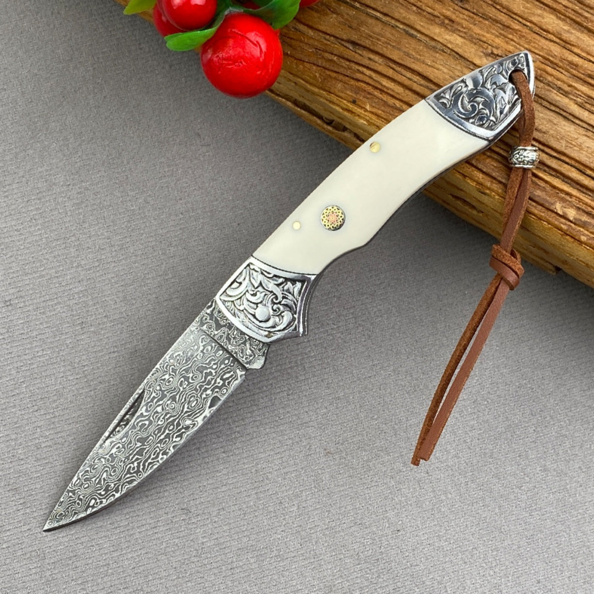 Handmade Damascus Steel Folding Knife Intricate Metal Engravings & Leather Lanyard – EDC Tool for Camping, Hunting & Daily Use