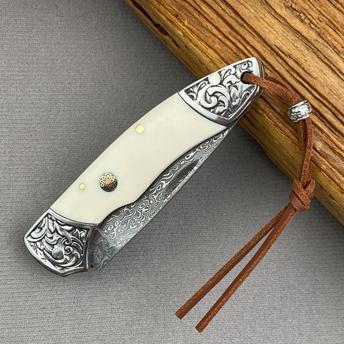 Handmade Damascus Steel Folding Knife Intricate Metal Engravings & Leather Lanyard – EDC Tool for Camping, Hunting & Daily Use