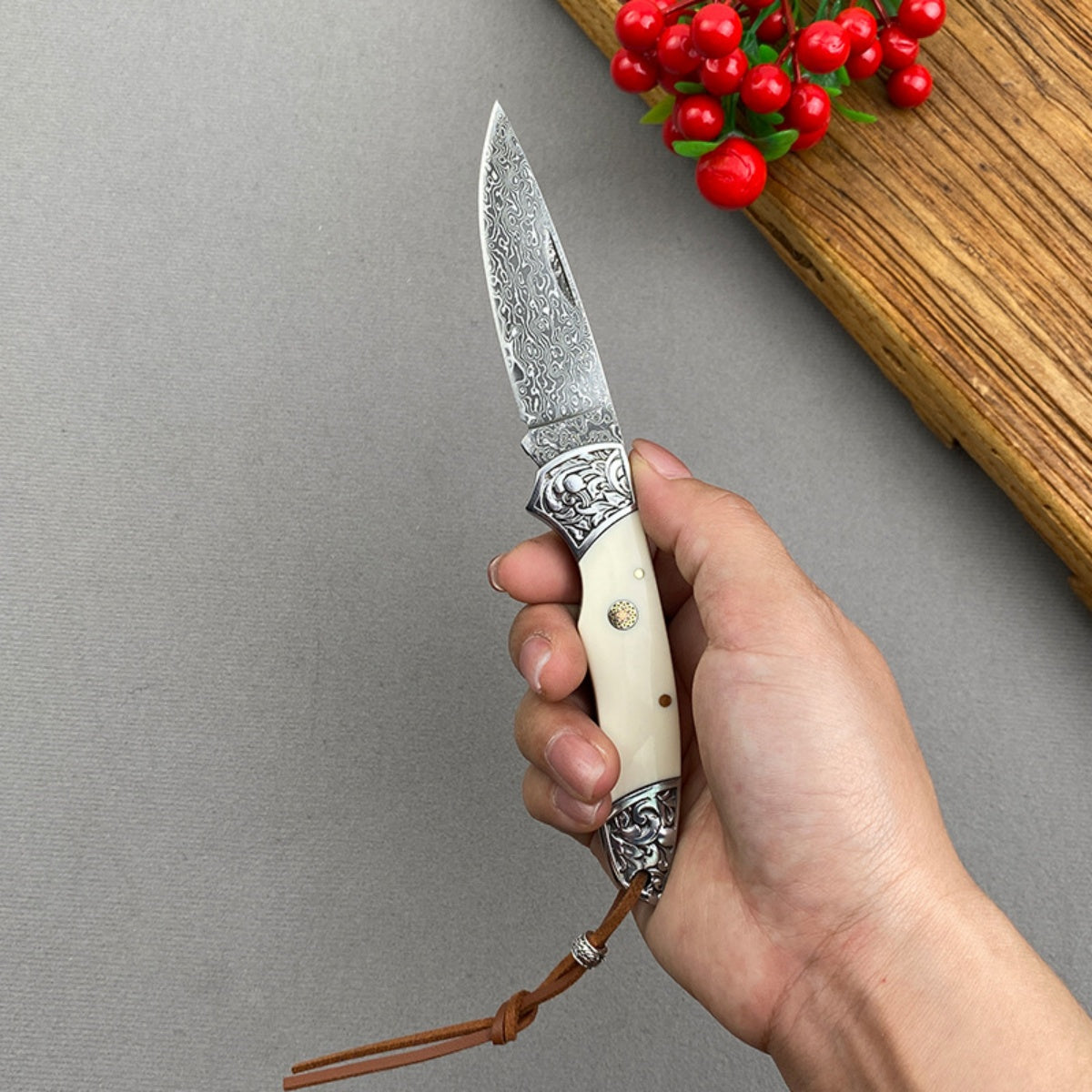 Handmade Damascus Steel Folding Knife Intricate Metal Engravings & Leather Lanyard – EDC Tool for Camping, Hunting & Daily Use
